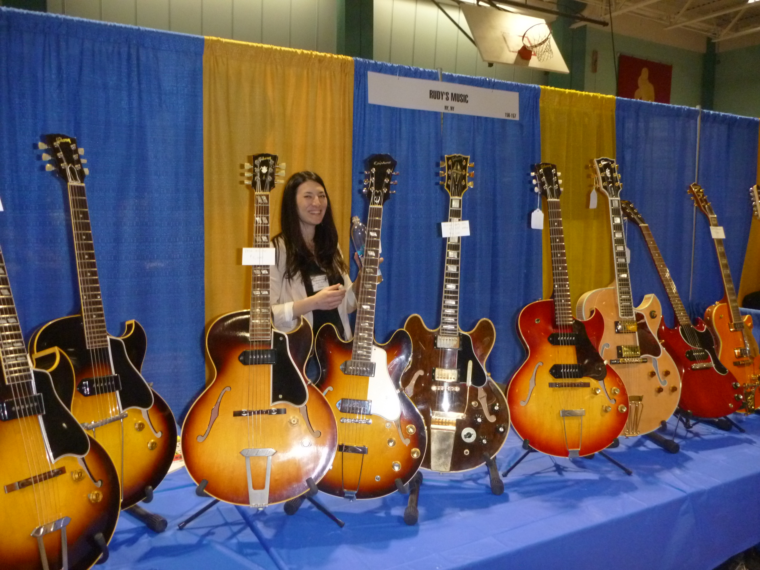 Ms. Stephanie Pensa of Rudy's Music with a fine collection of vintage archtops at the NY Guitar Expo.