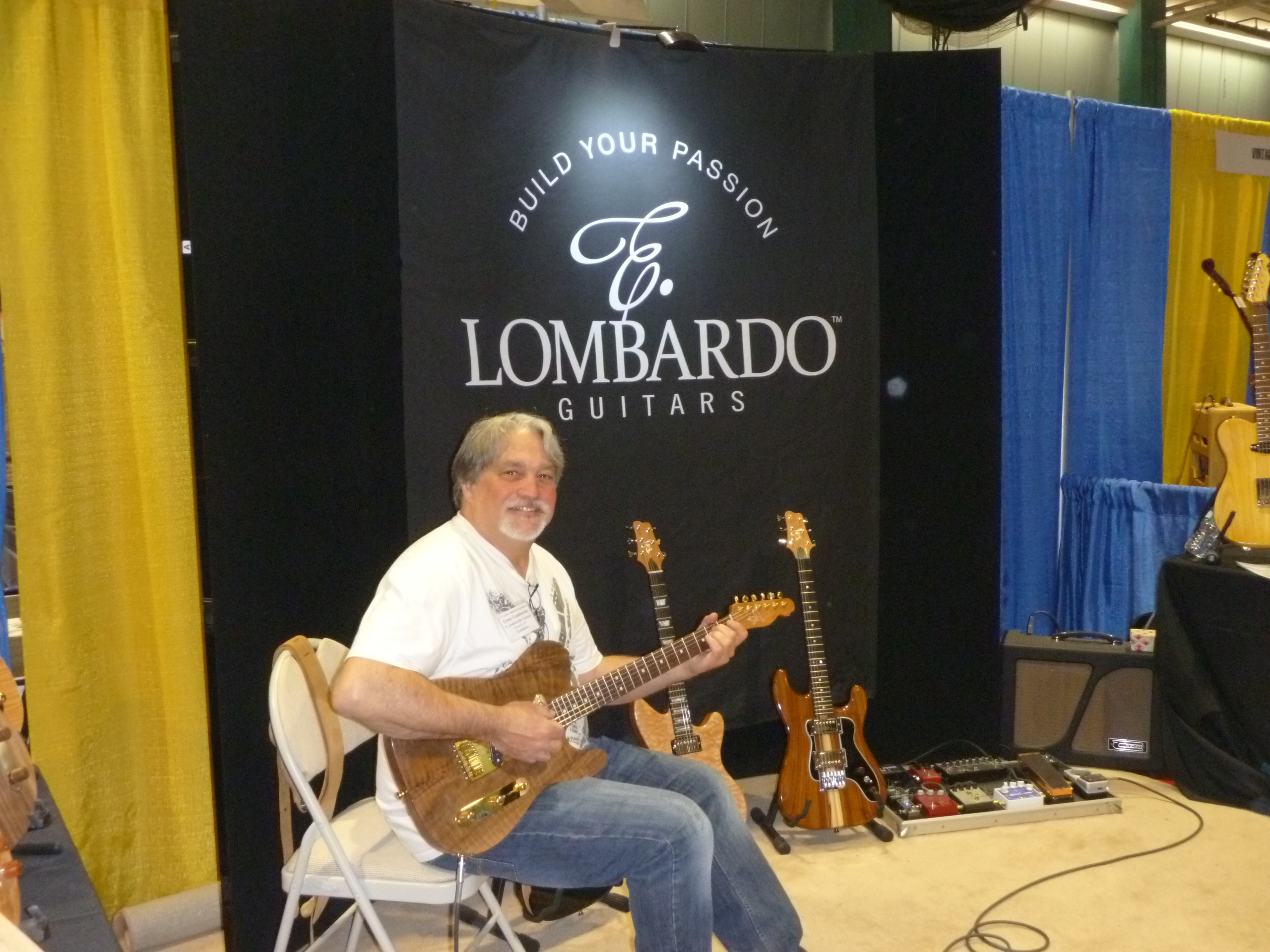 Ernie Lombardo of E. Lombardo Guitars with a fine looking display and better looking Lombardo Custom Guitar.