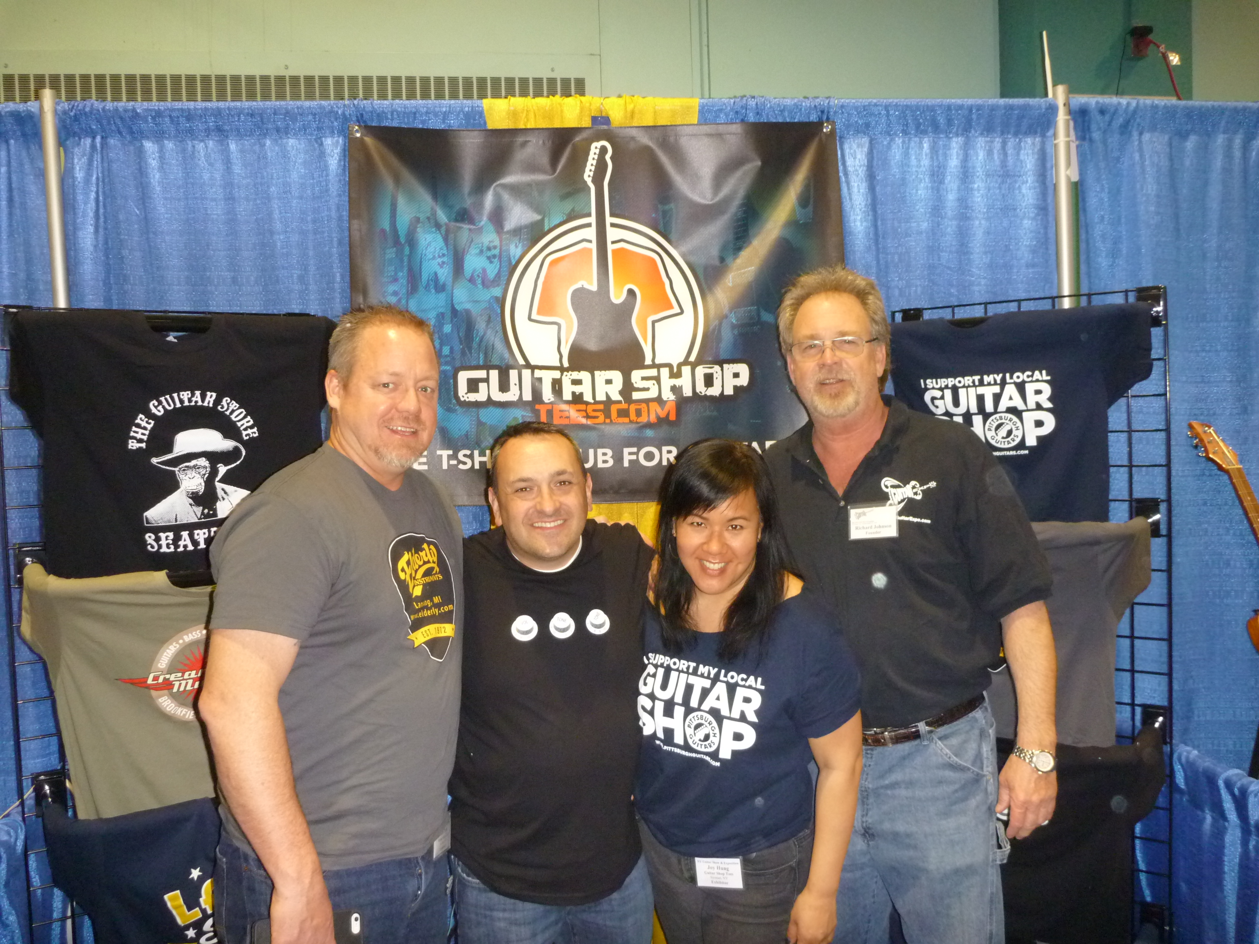 NY Guitar Show founder Rich Johnson (right) with sponsor Eric Feldman and crew of the Guitar Shop Tees.