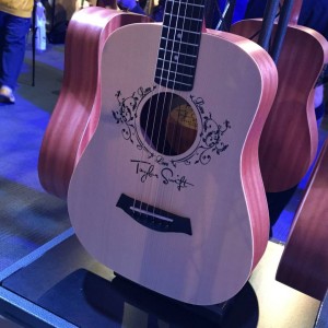 A Baby Taylor Swift hangs out on the Baby Taylor display in the Taylor Guitars #NAMM2015. #vintageguitar #guitarlove #TaylorGuitars #TaylorSwift #guitars #NAMM15 #NAMMshow #NAMM — in Anaheim, California.
