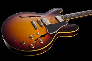 JOE BONAMASSA GIBSON CUSTOM ES-335 Based on one of his vintage models with a spliced top, Joe's signature 335 is a superb sounding and playing 335 with the best looking sunburst we have seen out of Gibson in years. Additionally, it has a woody tone and level of responsiveness to touch that is missing in many modern instruments. (Childs)