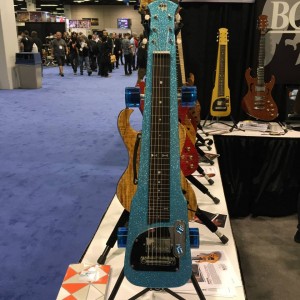 In California Ocean Blue Flake with wheels and dice details, this BGF Original Lap Steel from Brown's Guitar Factory is definitely a unique addition to any #guitar lover's collection. #NAMM2015 #steelguitar #guitarlove #vintageguitar #NAMM15 — in Anaheim, California.