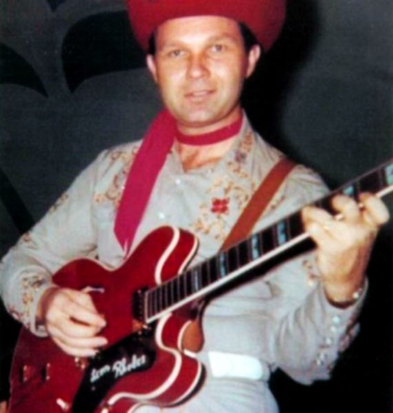 Leon in full Texas Troubadours stage attire with his cherry red Epiphone Sheraton