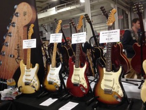 ’57 blonde and 2-tone sunburst Strats, and ’65 candy apple red and 3-tone sunburst Strats on display at We Buy Guitars.