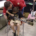 A young player with a Les Paul Custom.