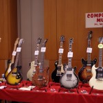 A table full of entry-level “vintage” guitars